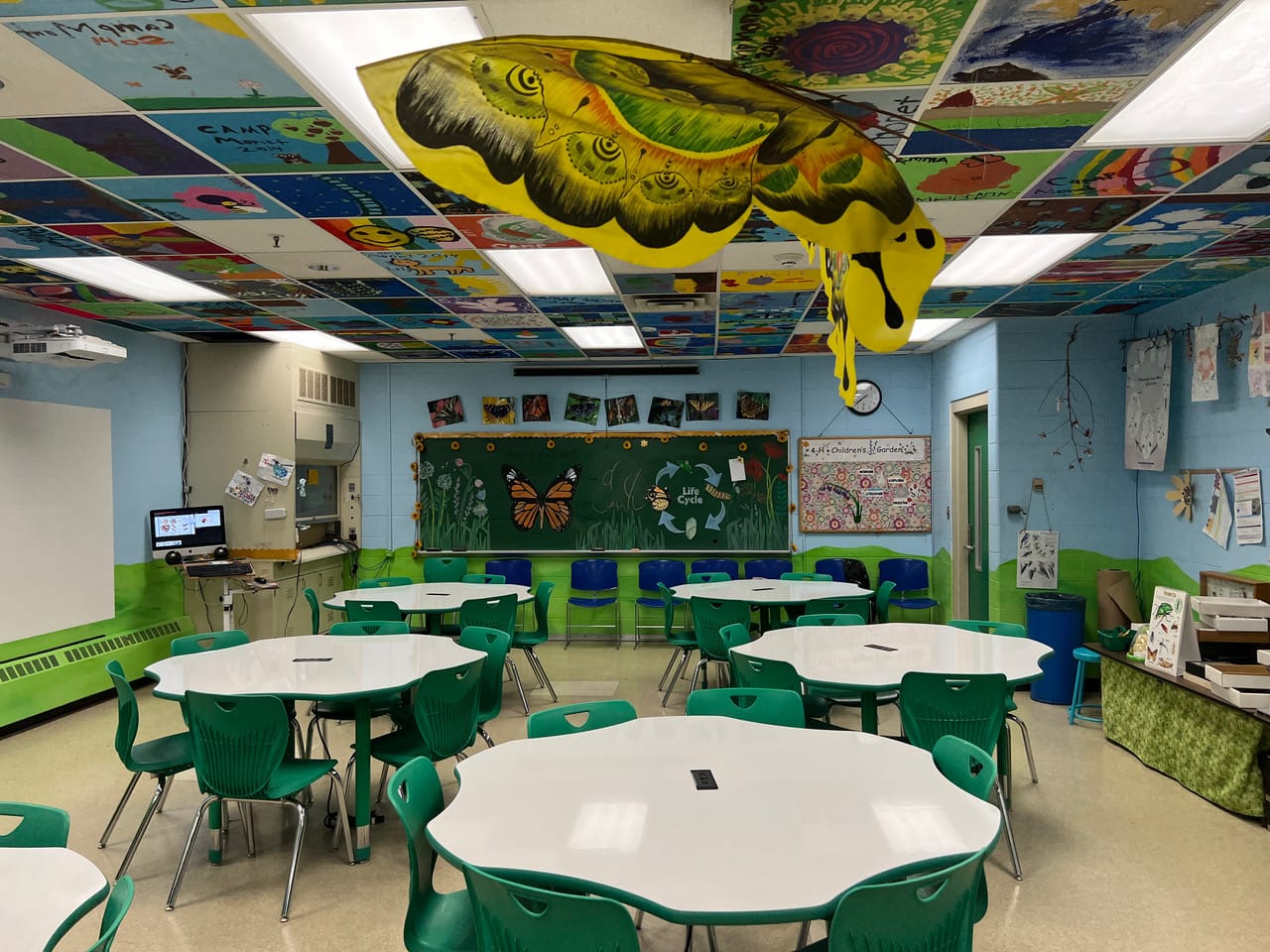 A classroom with a butterfly hanging from the ceiling.