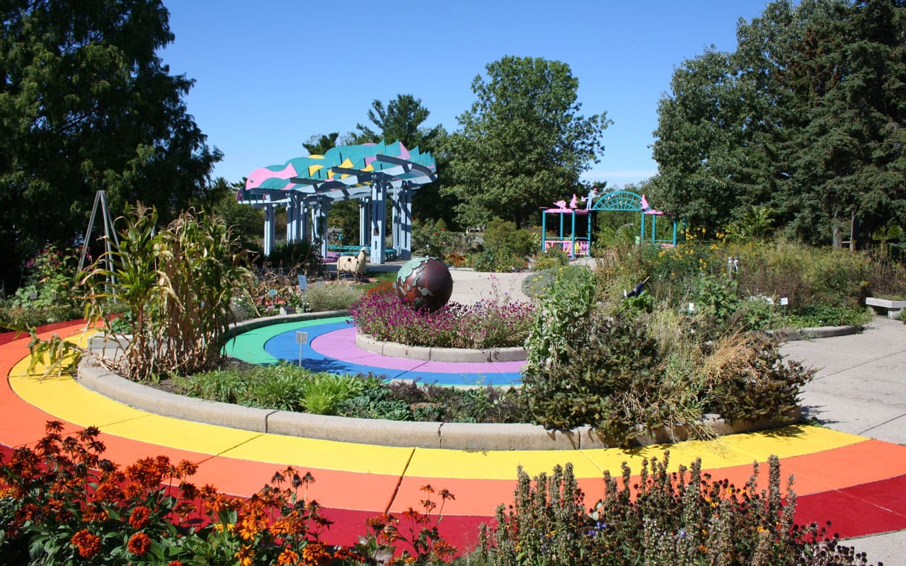 A rainbow colored path in a park.