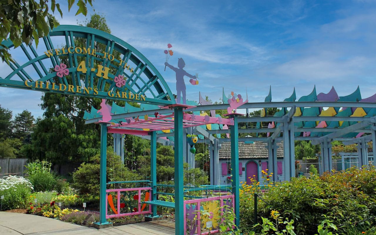 The entrance to a children's garden with colorful decorations.